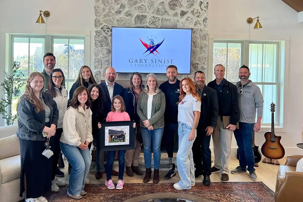 Sgt. Hargis and his family pose in their new home with the LP Building Solutions team