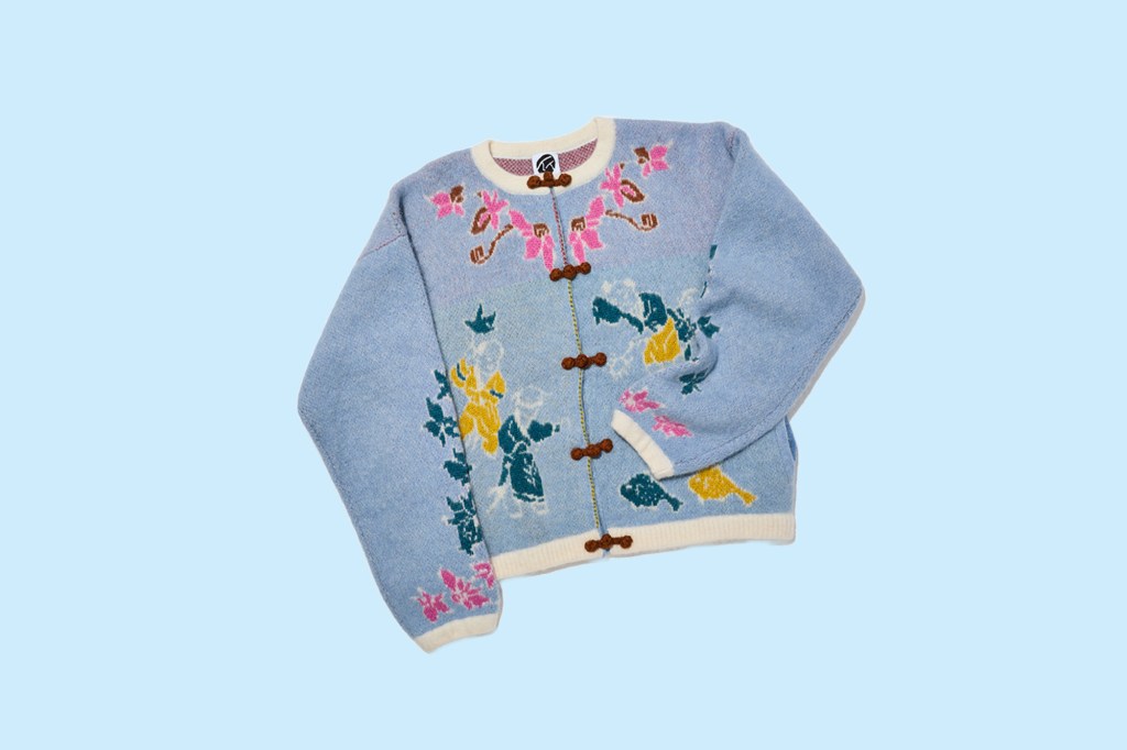 A blue sweater with a floral design